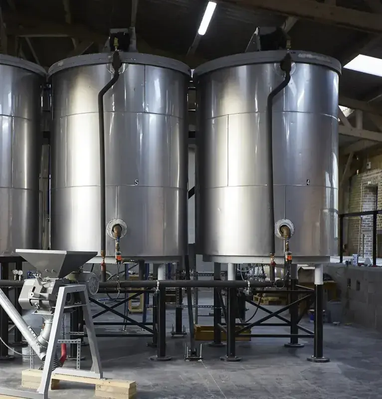 Cuves de brassage et de fermentation en inox dans le hall de production de la distillerie